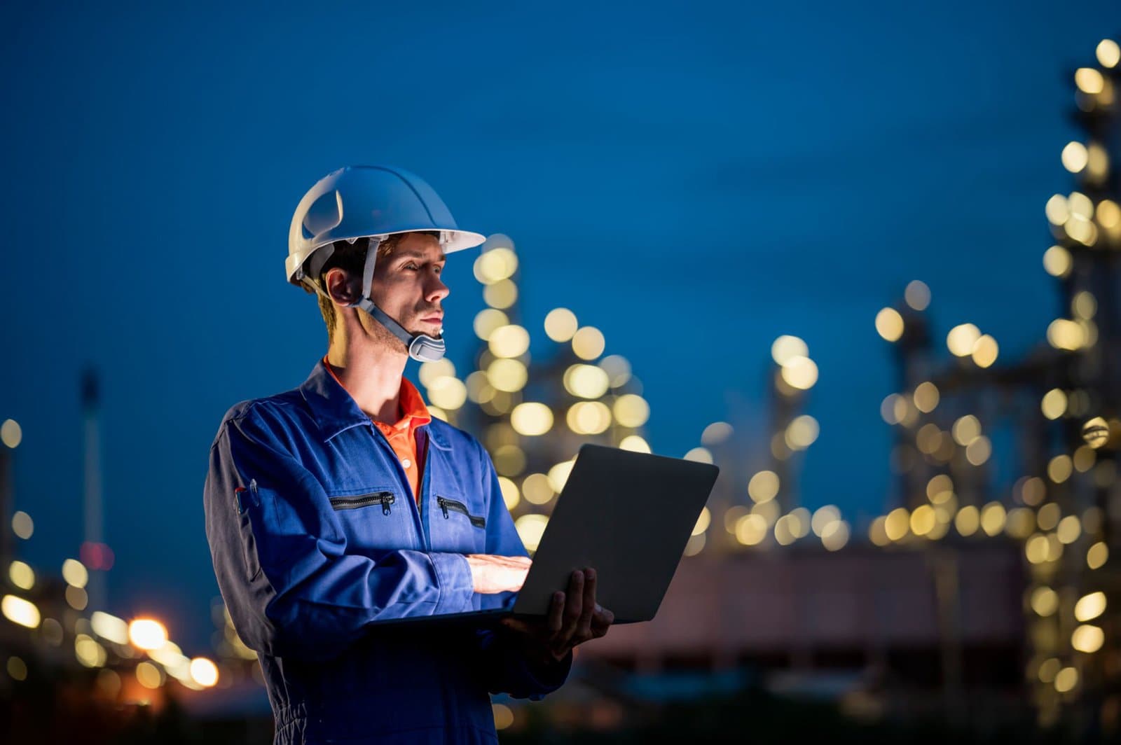 Bharat Tanks engineer reviewing plant data on site at dusk